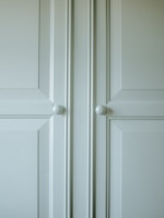 Close-up of a stylish kitchen cabinet with elegant handles.