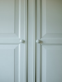Close-up of a modular cabinet door with a matte finish and modern handle.