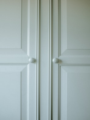 Close-up of a stylish kitchen cabinet with elegant handles.