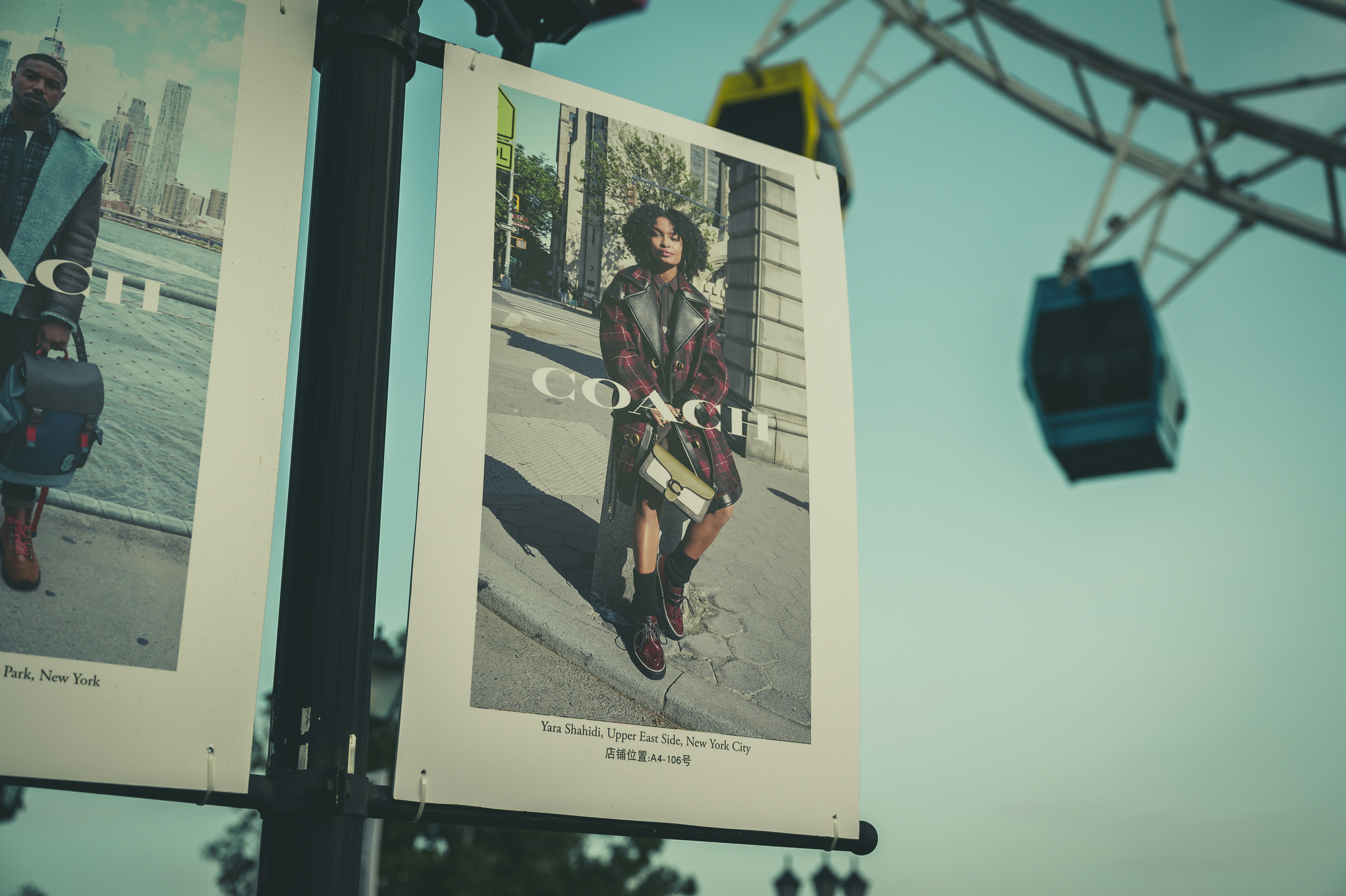 a couple of posters hanging from a pole