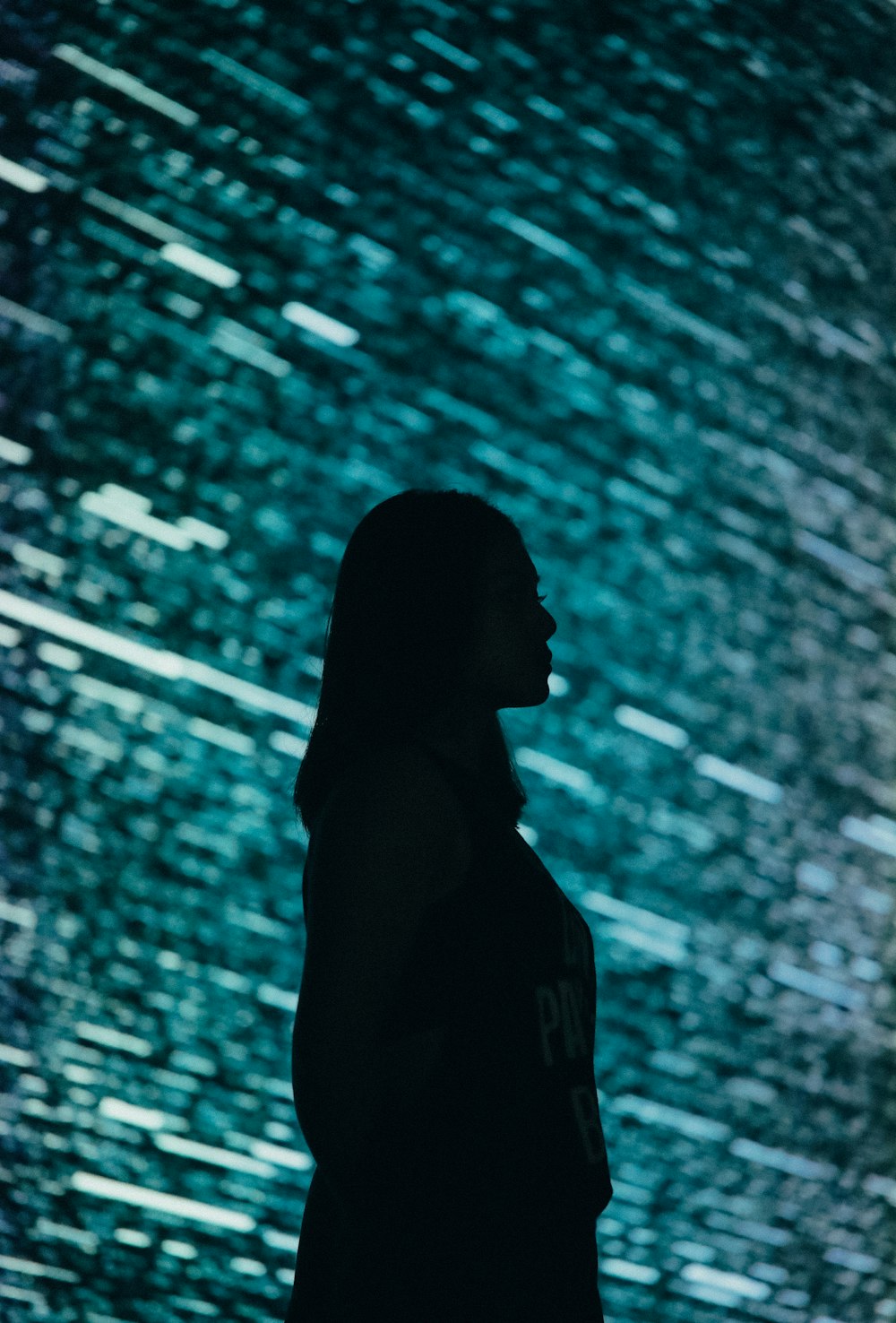 a woman standing in front of a large screen