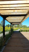 Outdoor pergola with aluminum structure providing shade in a garden