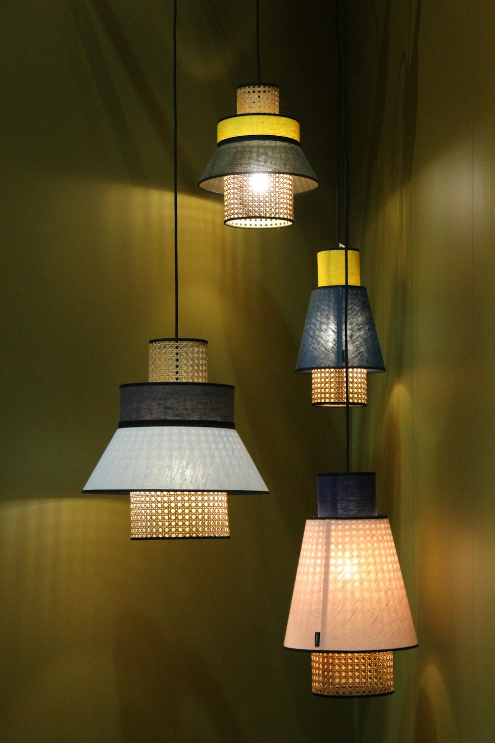 four assorted-color pendant lamps turned on