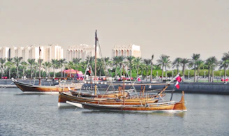 Historic Al Mukha port scene with wooden sailing ships, symbolizing the ancient coffee trade routes.
