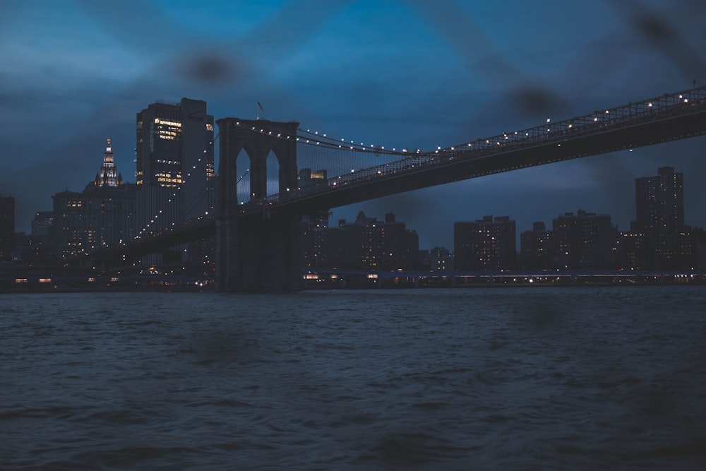 a view of a bridge over a body of water at night