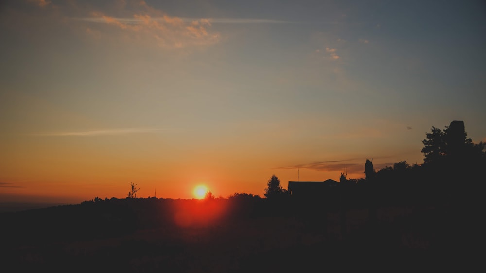 silhouette of mountain and trees during golden hour