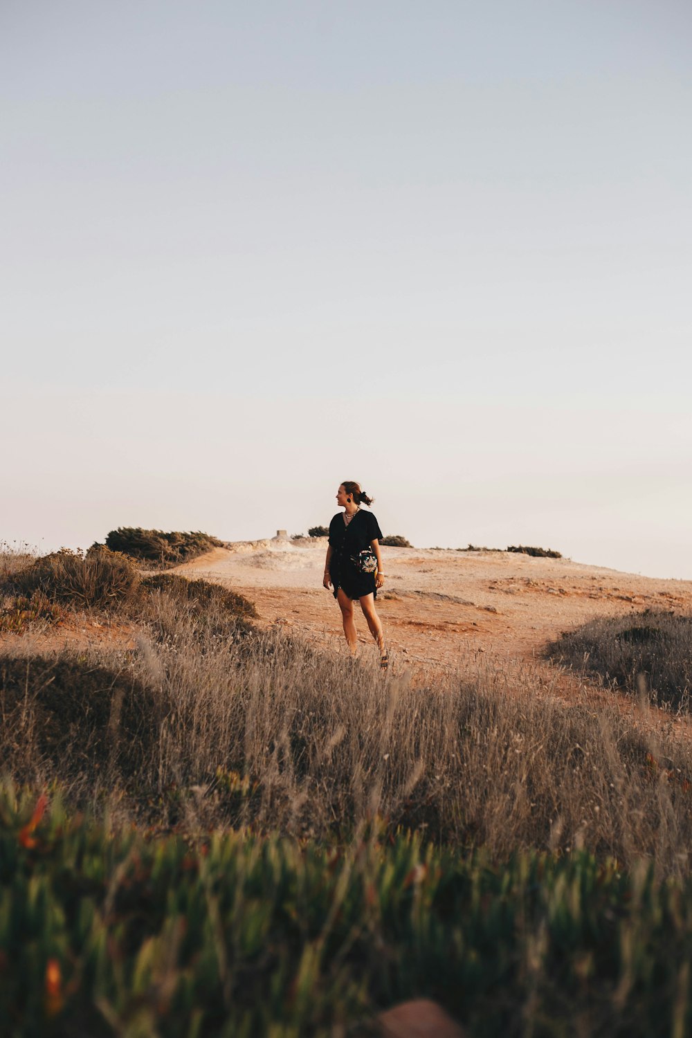 woman standing on brown field