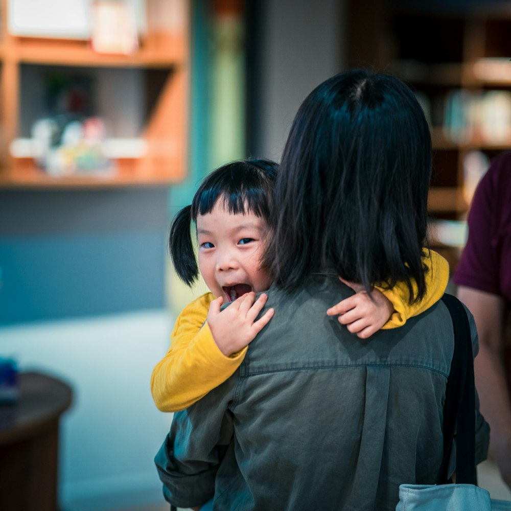 woman carrying girl