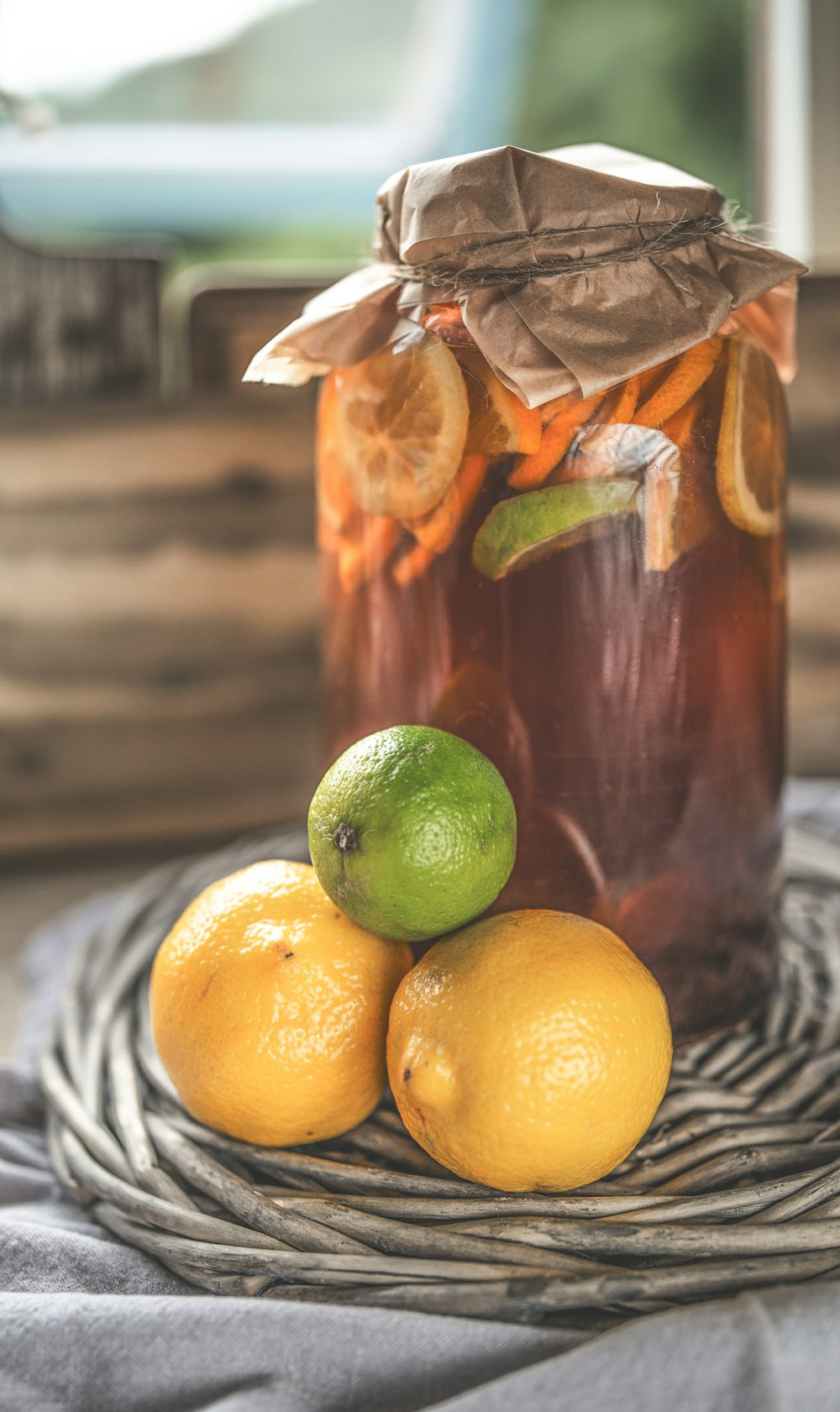 glass jar on gray surface beside lemons