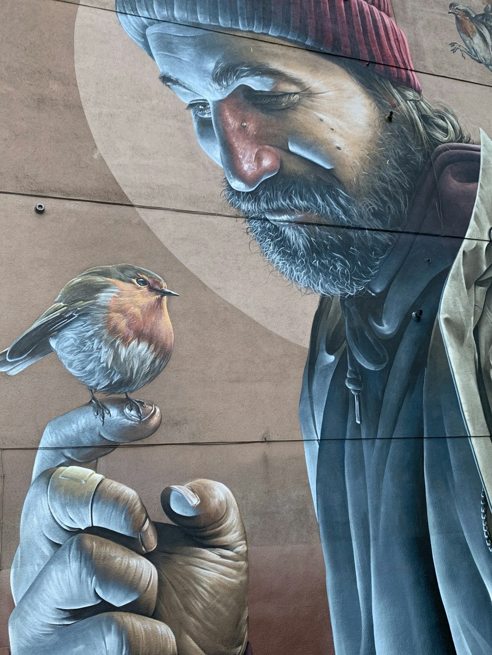 a mural of a man with a bird on his hand