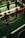 A foosball table is shown with red and black player figures positioned on the rods. The surface features the UEFA Champions League logo, indicating a themed table design.