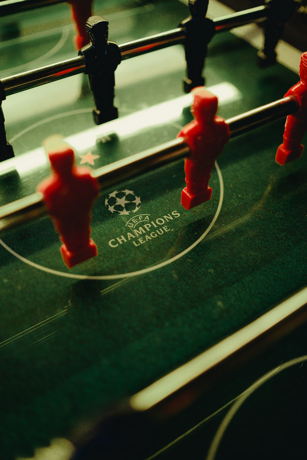 a close up of a foosball table with red foosball figures