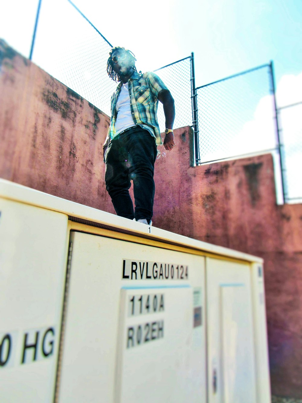 man standing on top of box during daytime