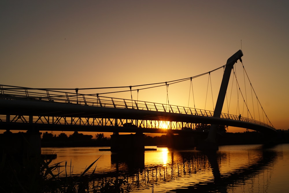 silhouette of bridge during golden hour