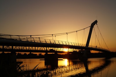 silhouette of bridge during golden hour