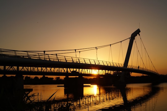 silhouette of bridge during golden hour in Décines-Charpieu France