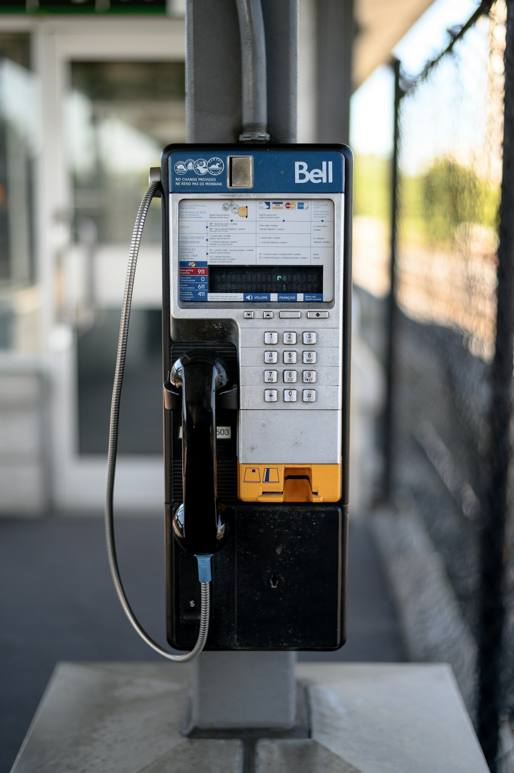 a pay phone sitting on top of a cement platform