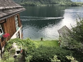 A serene lakeside view showcasing well-maintained gardens and landscaping.