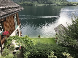 A serene lakeside view showcasing well-maintained gardens and landscaping.