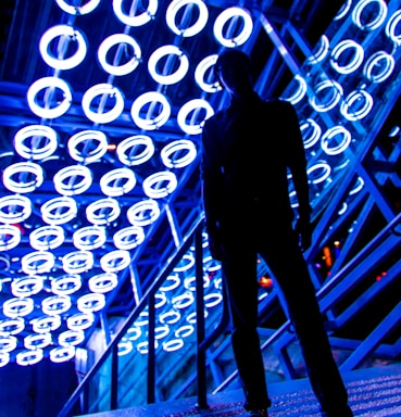 backgrounds for photo composition,how to photograph man standing near handrail under neon lights