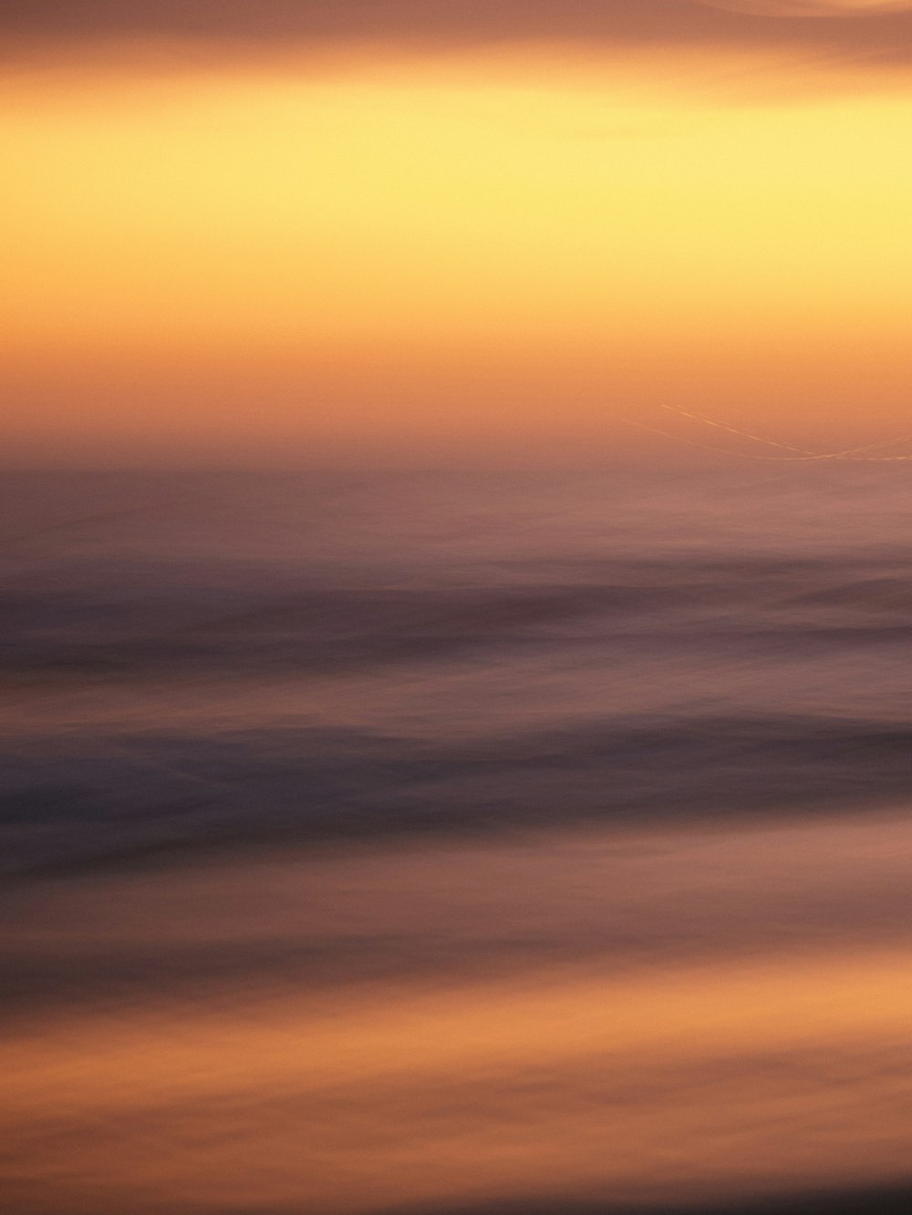 a blurry photo of the ocean at sunset