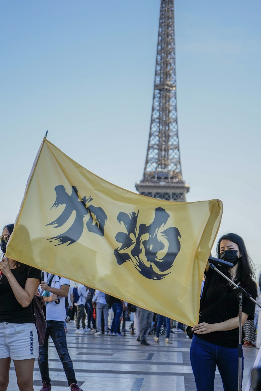 Two Women Holding Yellow Flag With Kanji Script Photo Free Human