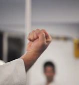 Close-up of hands demonstrating a self-defense technique in a workshop.