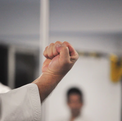 Close-up of hands demonstrating a self-defense technique in a workshop.
