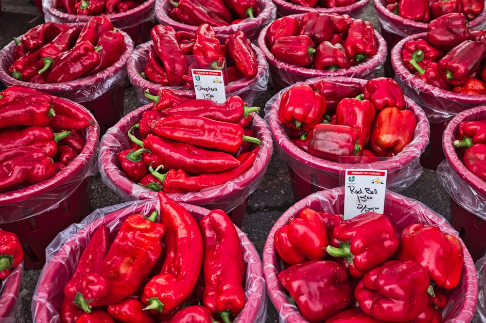 a bunch of baskets filled with lots of red peppers