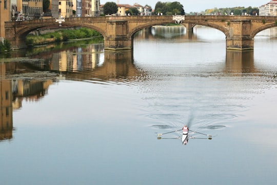boat on body of water during daytime in Florence Italy