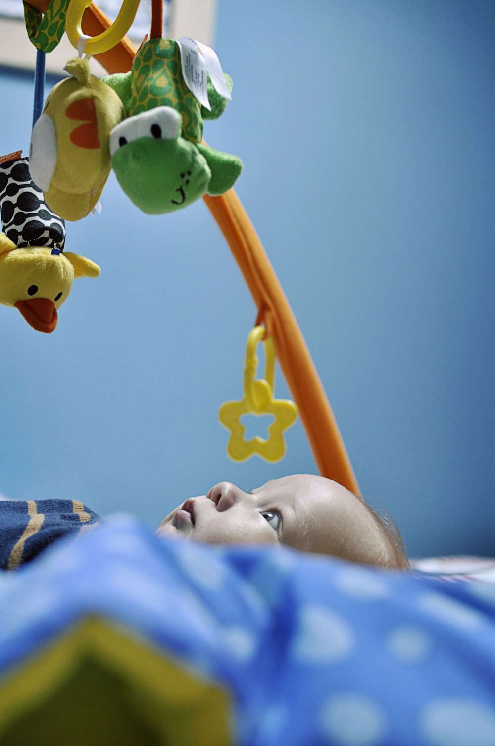 baby lying watching crib mobiles