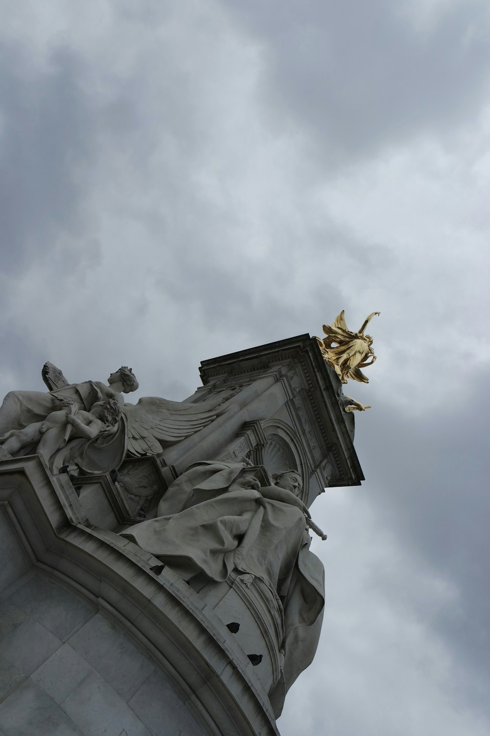 statue under cloudy sky during daytime