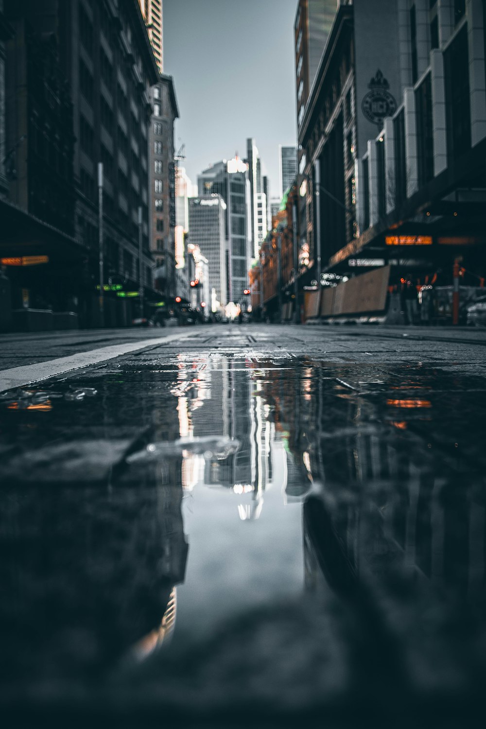 a city street with a puddle of water on the ground