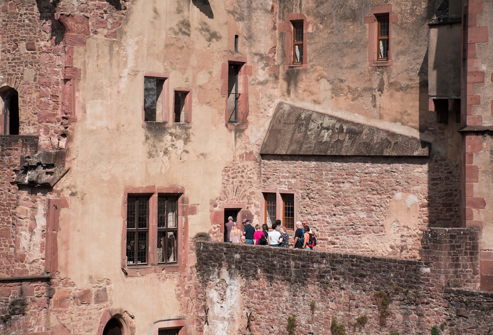 people standing on concrete building terrace