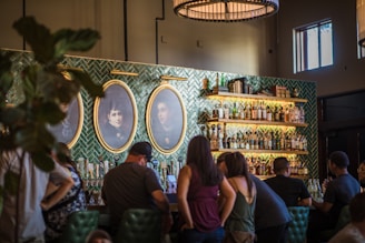 Guests sharing stories and drinks at a cozy, rustic tavern during an evening tour.