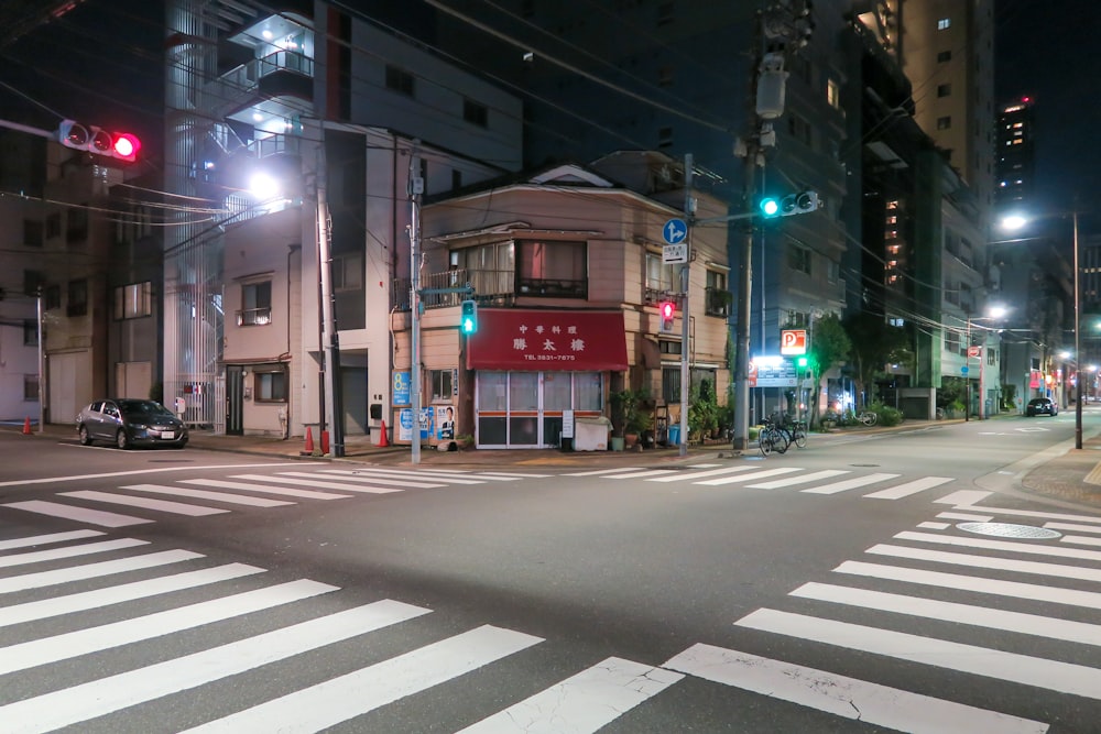 a city street at night with traffic lights