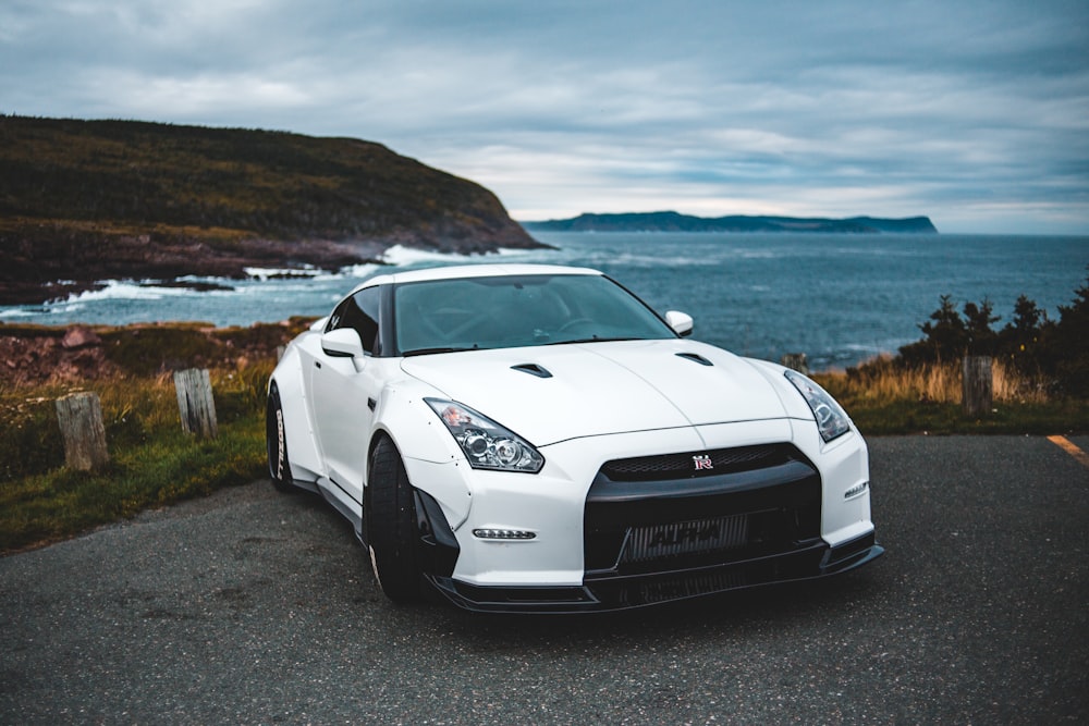 white coupe on paved road