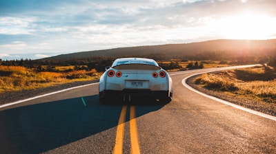 silver sports coupe on asphalt road