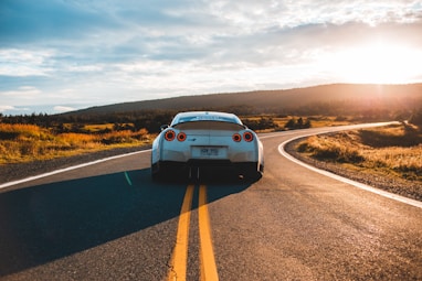 silver sports coupe on asphalt road