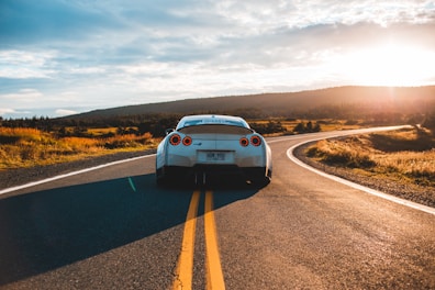 silver sports coupe on asphalt road