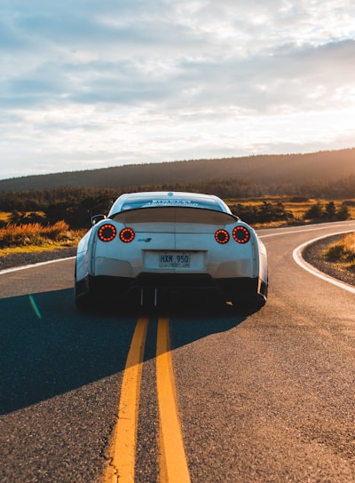 silver sports coupe on asphalt road