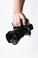 Close-up image of a team member capturing a moment with a professional camera.