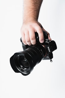 A close-up of a photographer capturing a soccer match with a professional camera.