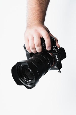 Close-up image of a team member capturing a moment with a professional camera.