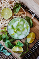 A refreshing glass of mango lassi garnished with mint leaves.