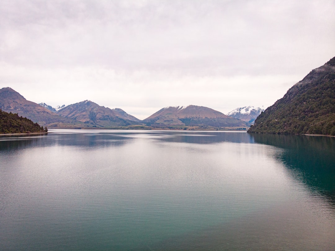 body of water under white sky