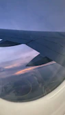 A serene sunset view from an airplane window, highlighting the calm of hassle-free travel.