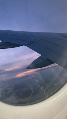 A serene sunset view from an airplane window, highlighting the calm of hassle-free travel.