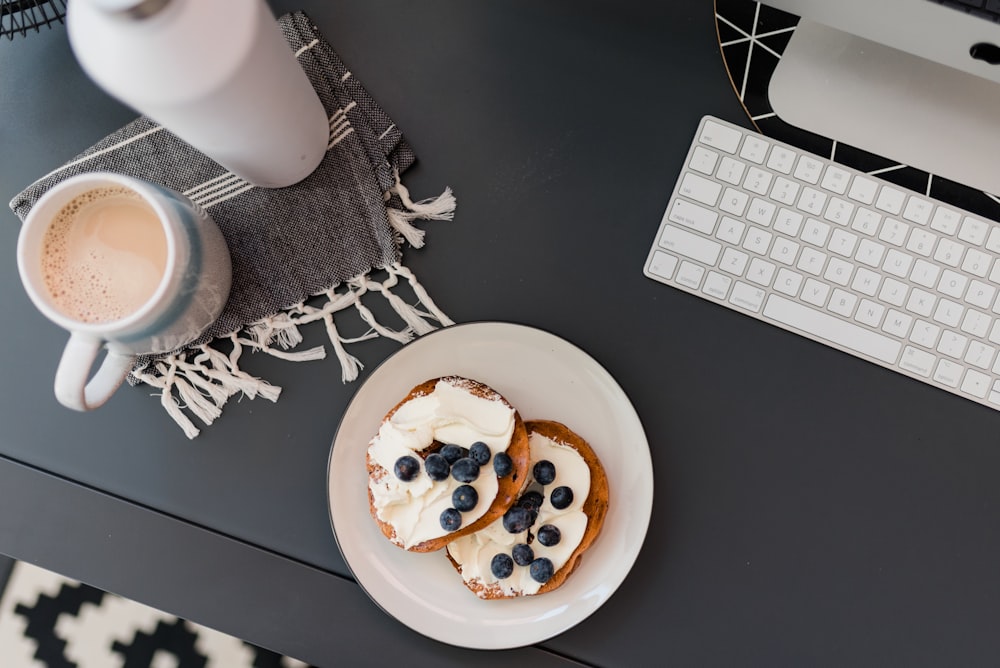 a plate of pancakes with whipped cream and blueberries