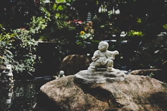 Marble statue of a joyful child reflecting warmth and care.